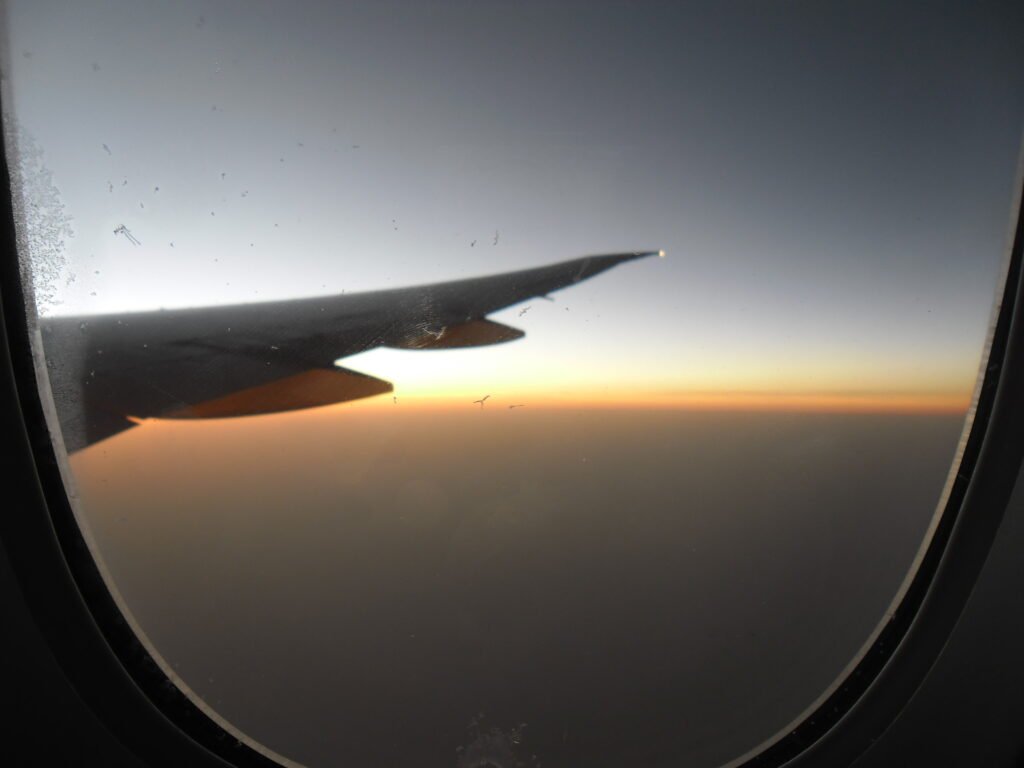Plane above the clouds at sunrise